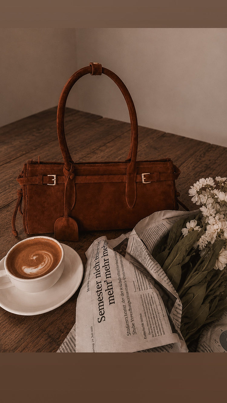 Luxury handbag sitting on table outside